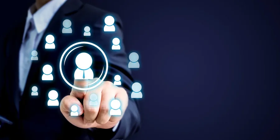 Businessman interacting with virtual icons representing user profiles, highlighting the concept of an Employee Self-Service Portal for workforce management.