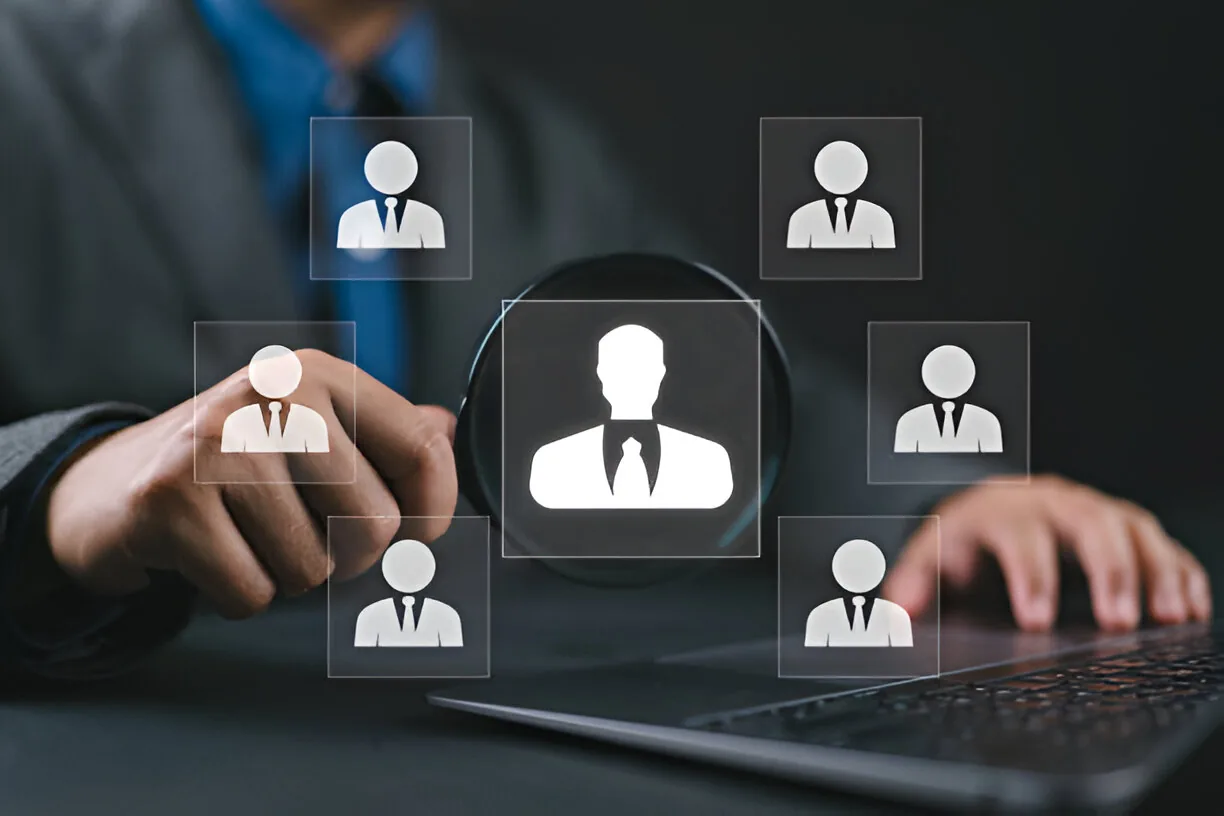 Business professional using Human Resource Management Information Systems (HRMIS) to analyze employee data on a digital interface.