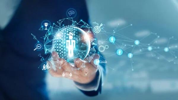 Digital representation of HR technology in UAE showing a hand holding a glowing globe with human icons and network connections, symbolizing modern HR tech trends in UAE.